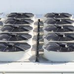 ac system with air conditioning units on roof of building